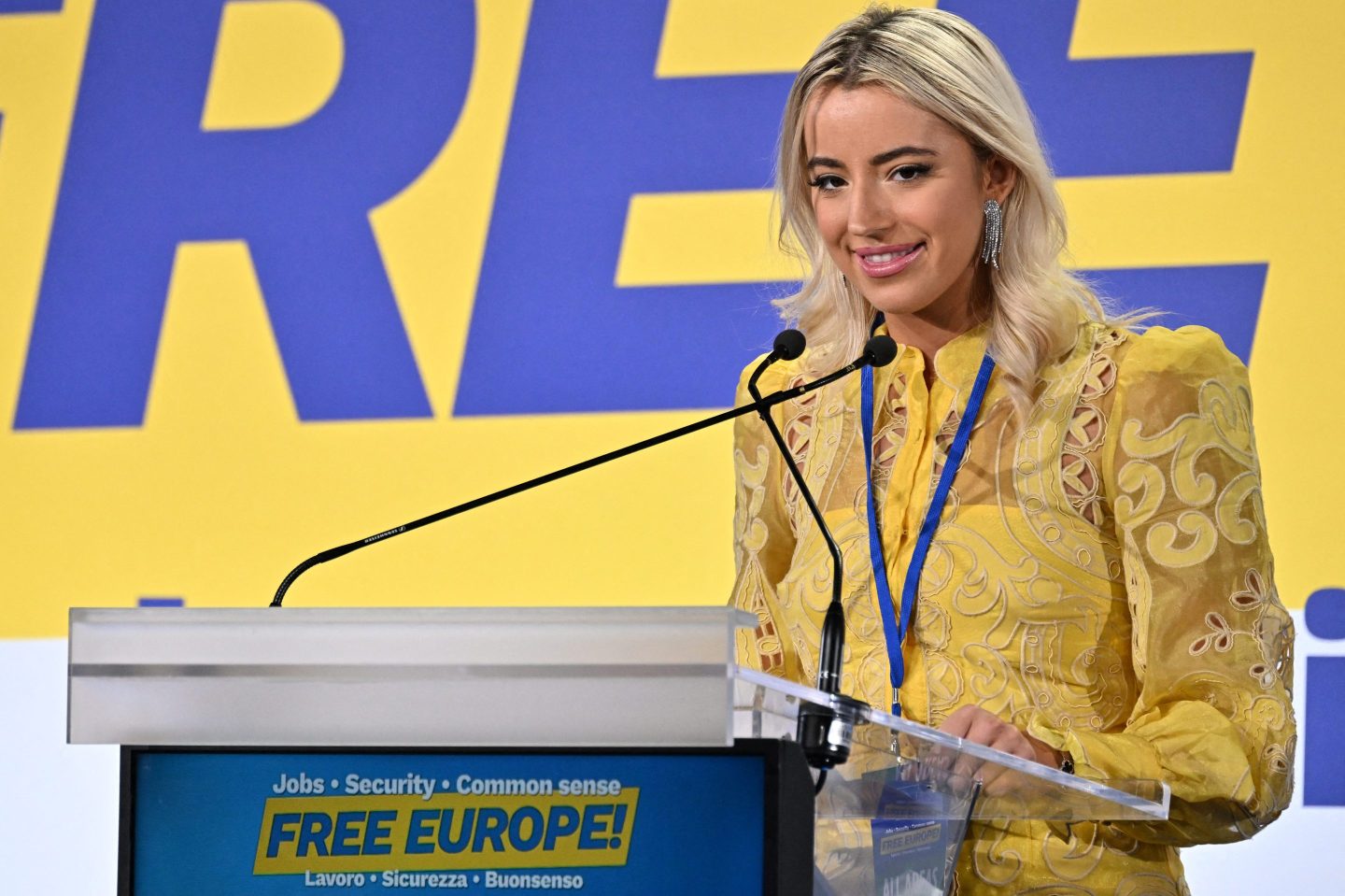 Ashley St Clair in front of a yellow sign