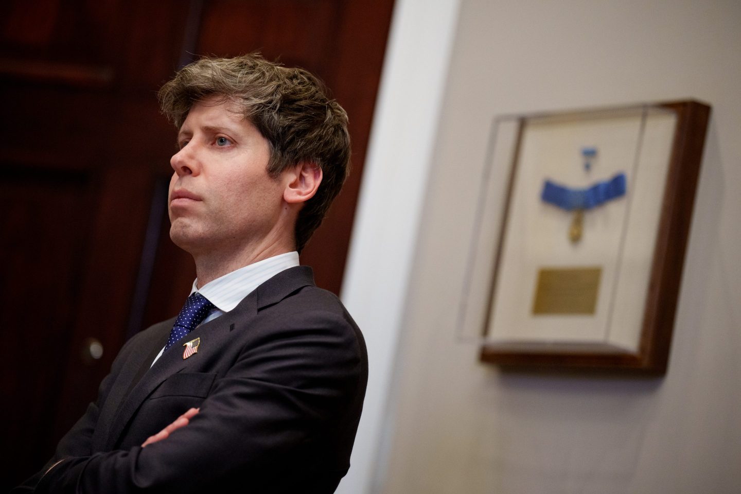 Sam Altman stands.