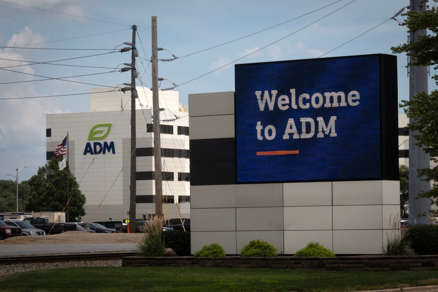 The company logo is displayed in front of the Archer Daniels Midland (ADM) facility in Decatur, Illinois.