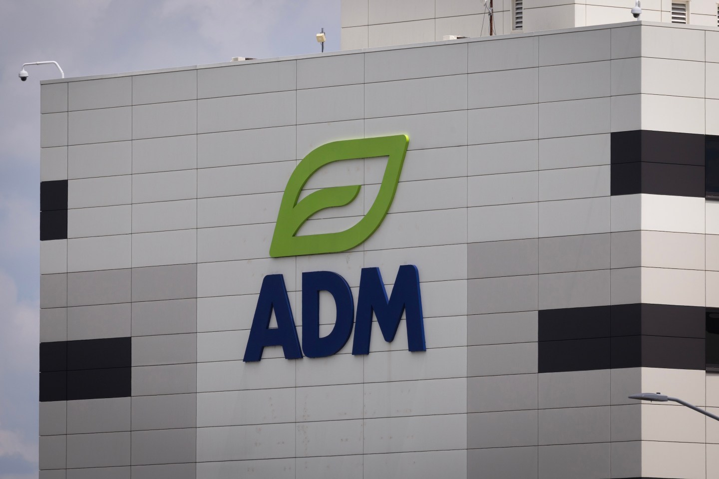 The company logo is displayed on a building in the Archer Daniels Midland (ADM) complex in Decatur, Illinois.