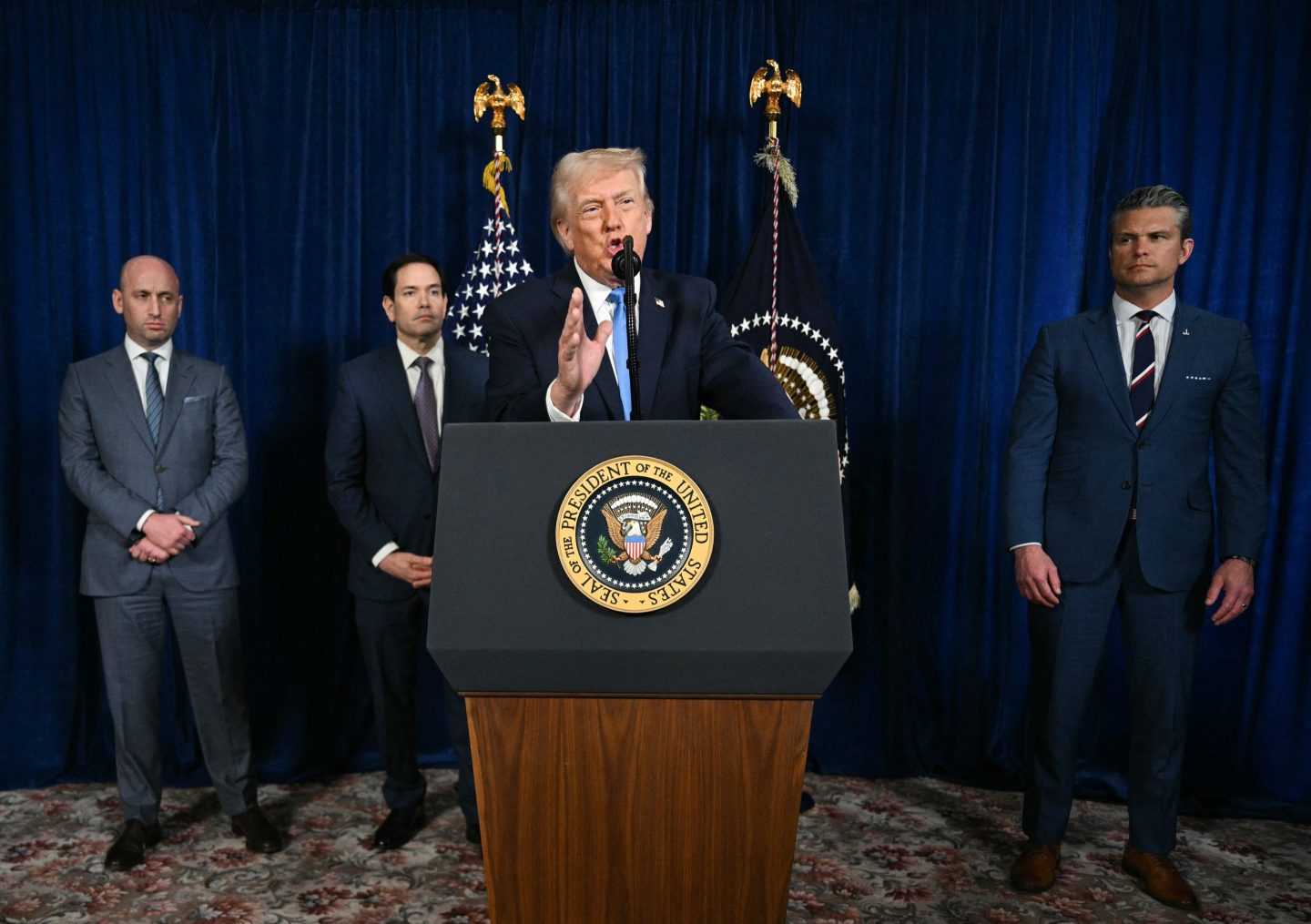 US President Donald Trump, alongside Deputy Chief of Staff Stephen Miller, Secretary of State Marco Rubio, and US Secretary of Defense Pete Hegseth, speaks to the press following US military actions in Venezuela, at his Mar-a-Lago residence in Palm Beach, Florida, on January 3, 2026. President Trump said Saturday that US forces had captured Venezuelan leader Nicolas Maduro after launching a "large scale strike" on the South American country.