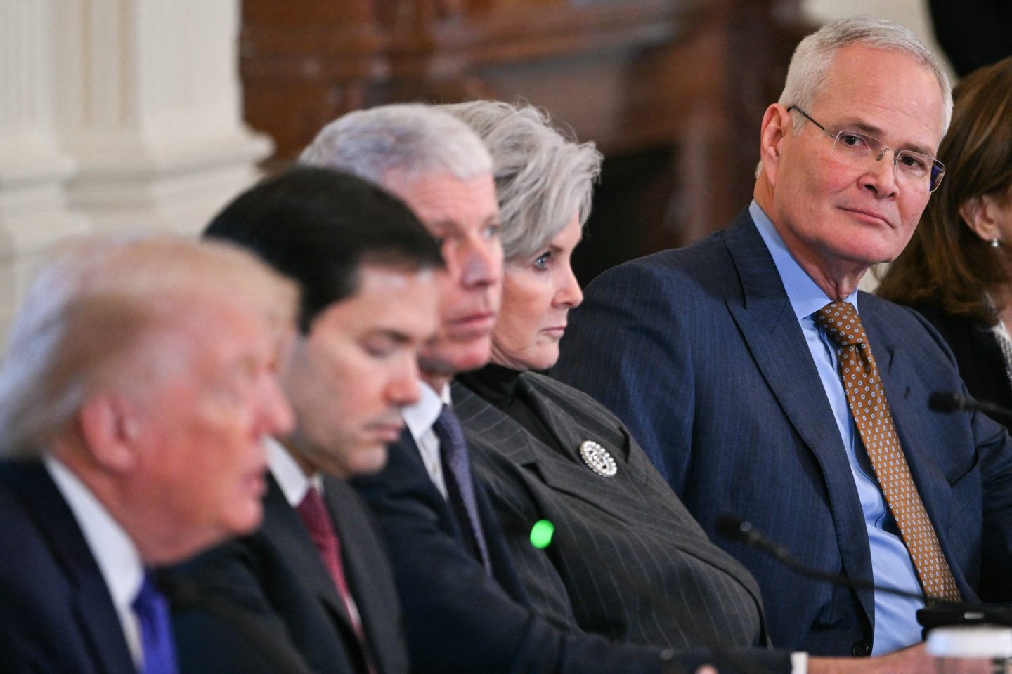 Exxon Mobil CEO Darren Woods, seated to the right, listens as U.S. President Donald Trump, left, speaks during a meeting with oil company executives in the East Room of the White House in Washington, DC on Jan. 9, 2026. President Trump is aiming to convince oil executives to support his plans in Venezuela, a country whose energy resources he says he expects to control for years to come. U.S. forces seized Venezuelan president Nicolas Maduro in a sweeping military operation on Jan. 3, with Trump making no secret that control of Venezuela's oil was at the heart of his actions.