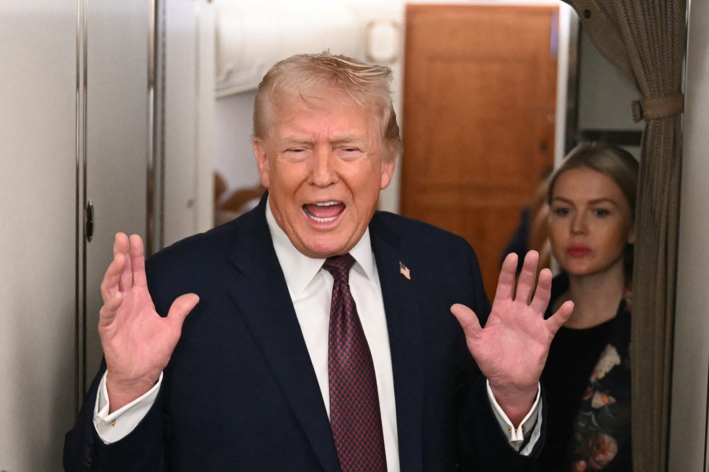 U.S. President Donald Trump speaks to the press aboard Air Force One on January 11, 2026. Trump said Sunday his administration was working well with Venezuela's interim leader Delcy Rodriguez and that he would be open to meeting with her.