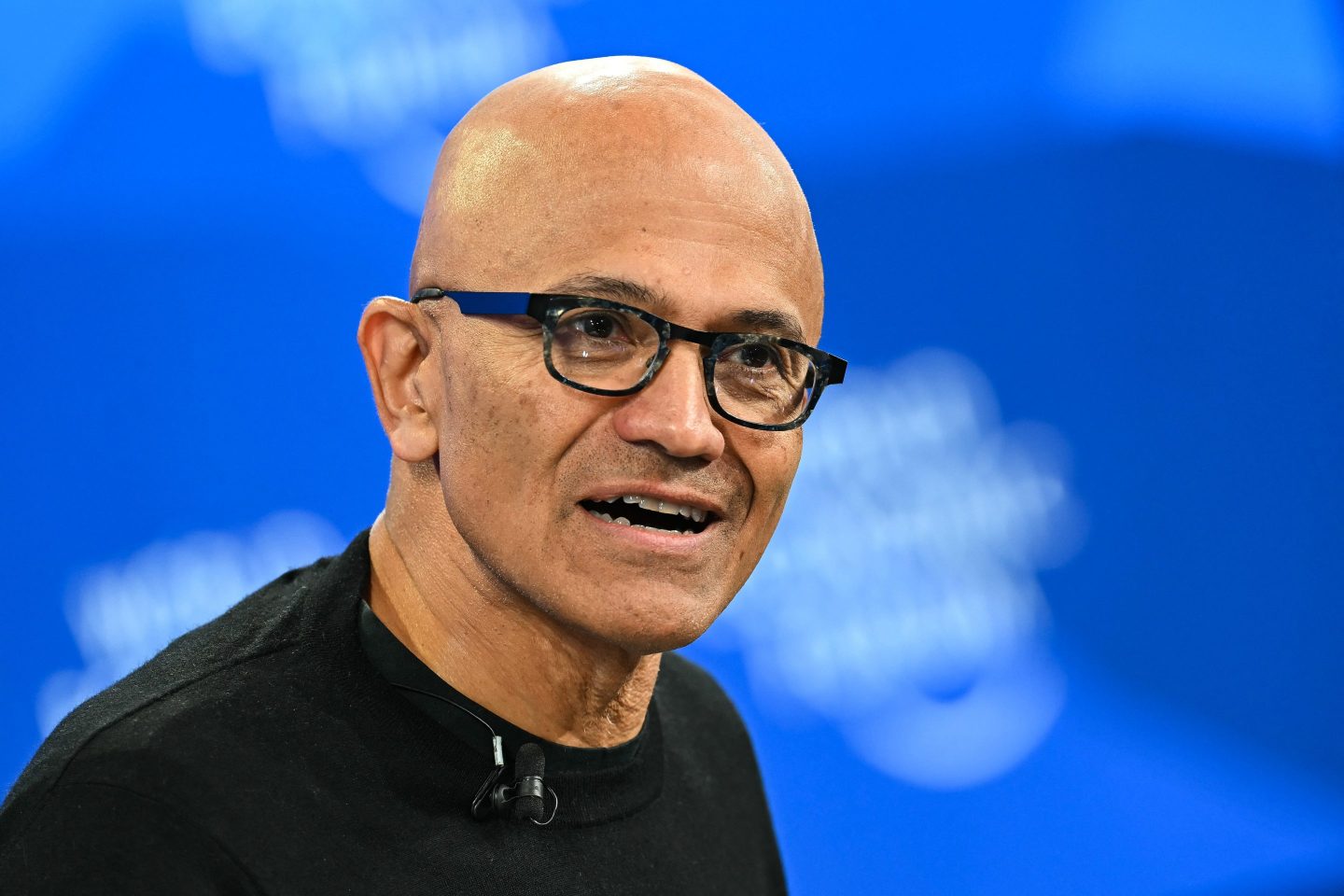 Bald man with glasses and black shirt.