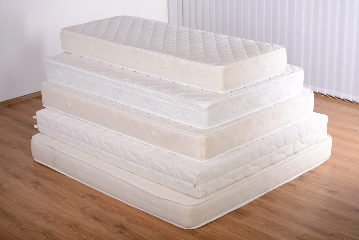 A pile of different-sized mattresses.